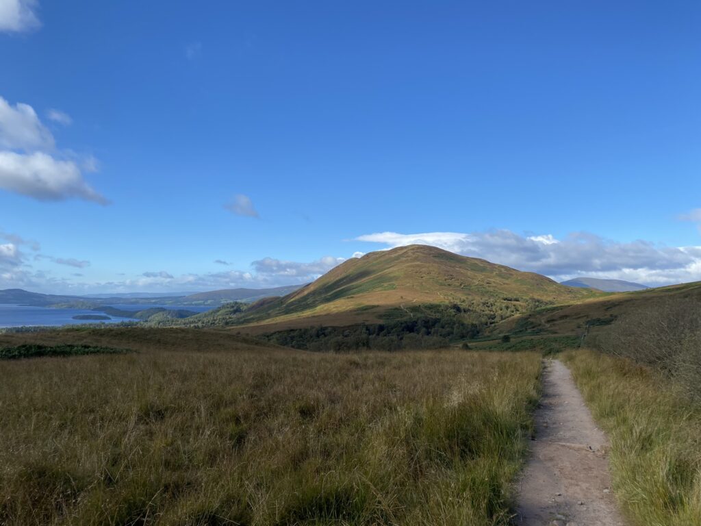 Trail leading up to Conic Hill, Loch Lomond in the background.