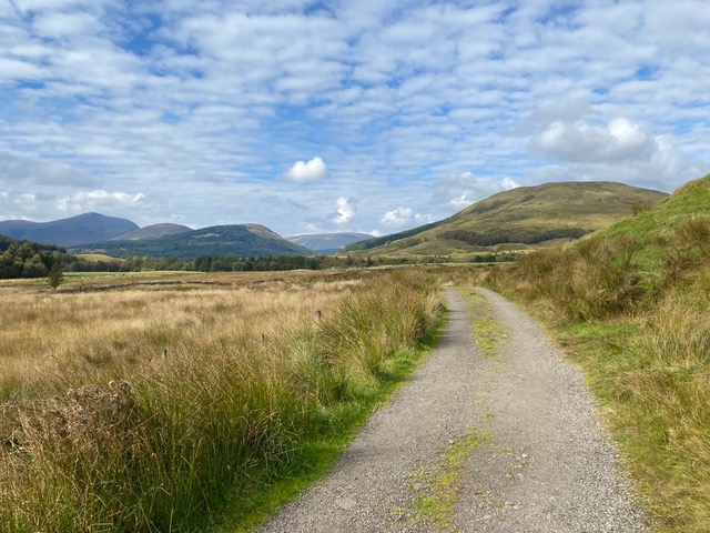 Blue cloud skies walking the gravel trail in Strath Fillan.